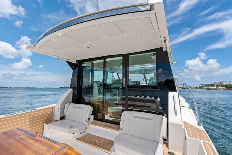 Slide: The Image of 2024 Tiara 48 LE luxury yacht with spacious deck and modern seating on open water. - 31
