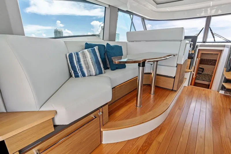 Slide: The Image of Luxurious interior of 2024 Tiara 48 LE yacht with elegant seating and wooden flooring. - 36