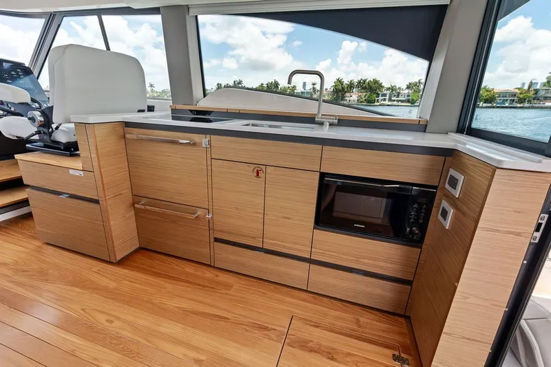 Slide: The Image of Luxurious 2024 Tiara 48 LE yacht interior with modern kitchen and scenic water view. - 39