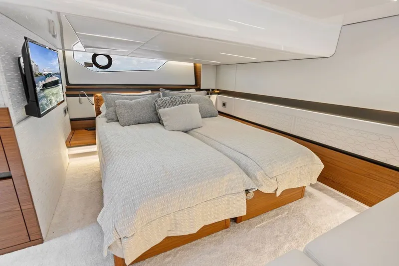 Slide: The Image of Luxurious 2024 Tiara 48 LE yacht bedroom with modern decor and comfortable bedding. - 56