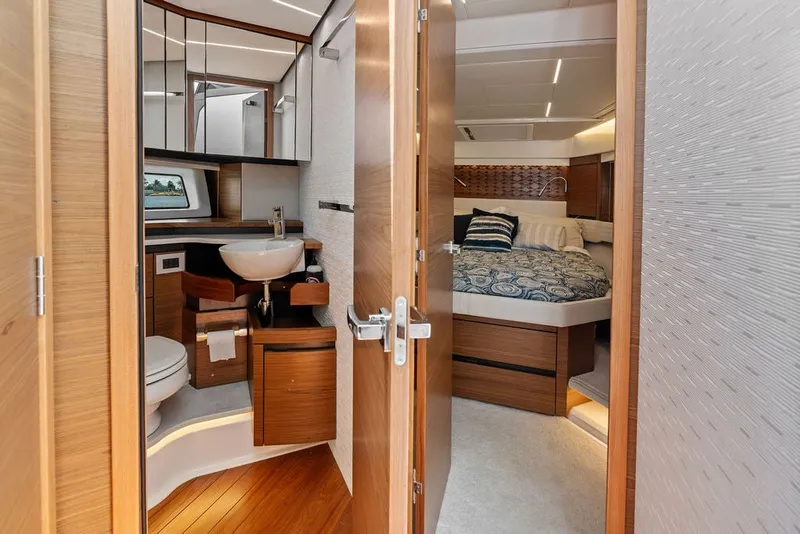 Slide: The Image of Luxurious interior of 2024 Tiara 48 LE yacht featuring bedroom and bathroom. - 54