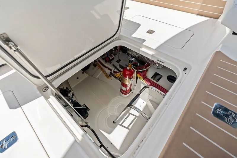 Slide: The Image of 2024 Tiara 48 LE yacht engine compartment with fire extinguisher and wiring. - 62