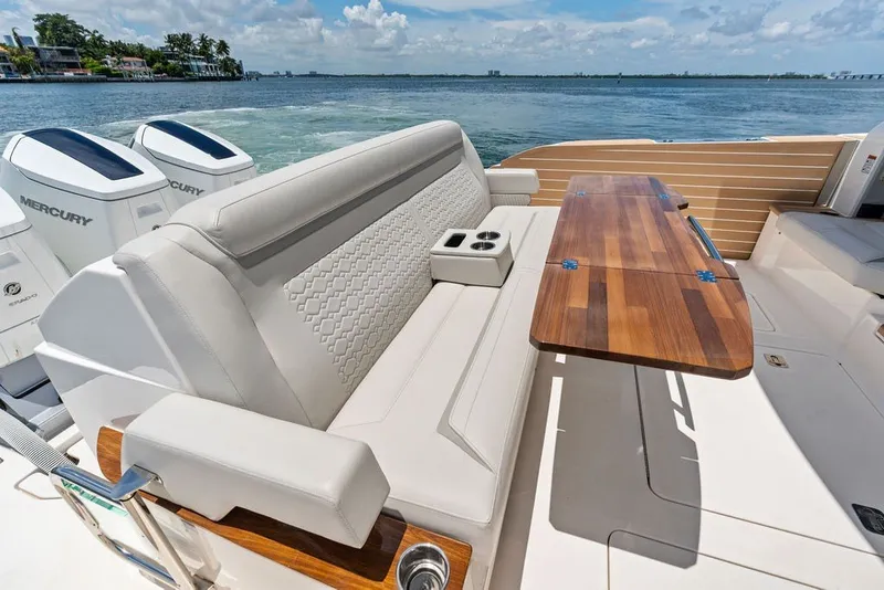 Slide: The Image of Luxurious seating and table on 2024 Tiara 48 LE yacht, with scenic ocean view. - 28