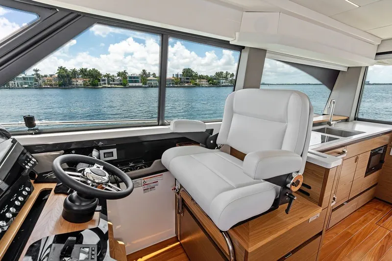 Slide: The Image of Luxurious interior of 2024 Tiara 48 LE yacht with helm and kitchen area. - 45