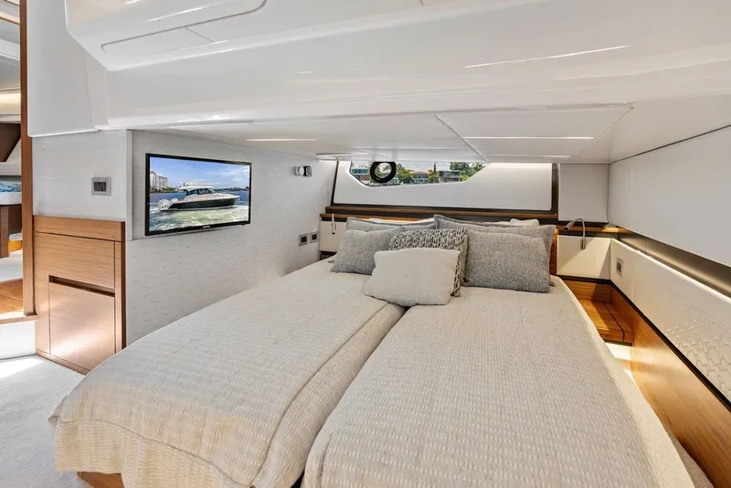 Slide: The Image of Luxurious 2024 Tiara 48 LE yacht bedroom with elegant bedding and modern decor. - 57