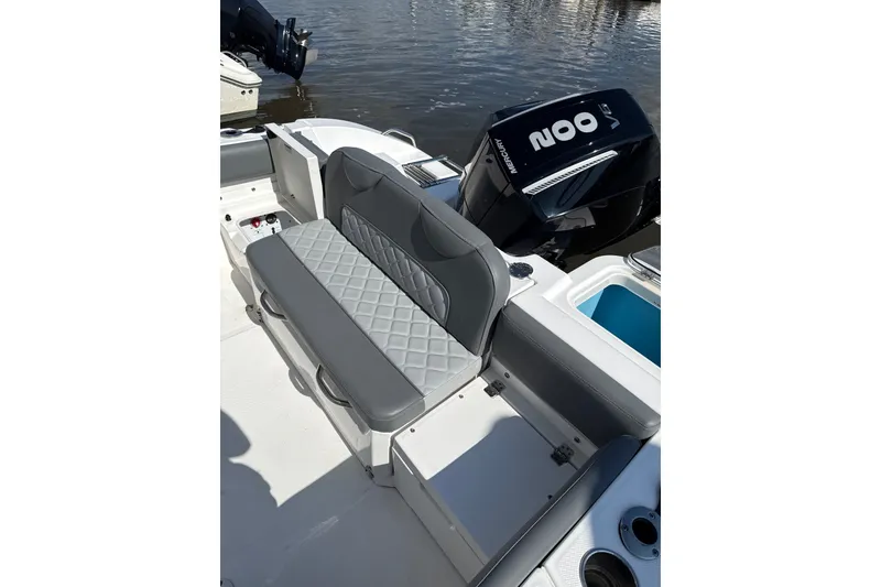 Slide: The Image of 2024 NauticStar 222L Offshore boat with cushioned seating and powerful outboard motor. - 5
