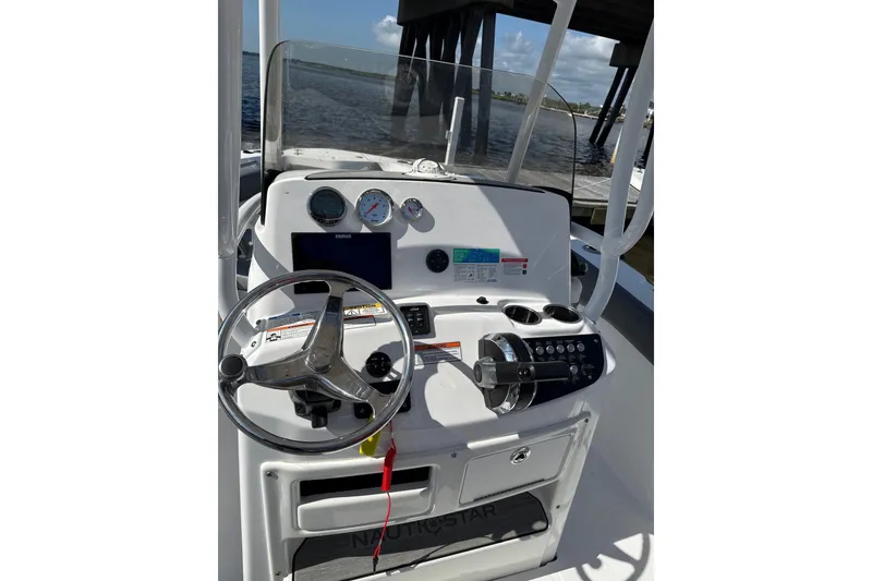 Slide: The Image of 2024 NauticStar 222L Offshore boat console with steering wheel and gauges. - 3
