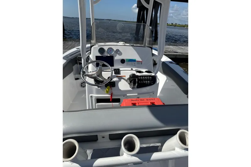 Slide: The Image of 2024 NauticStar 222L Offshore boat interior with steering wheel and control panel. - 2