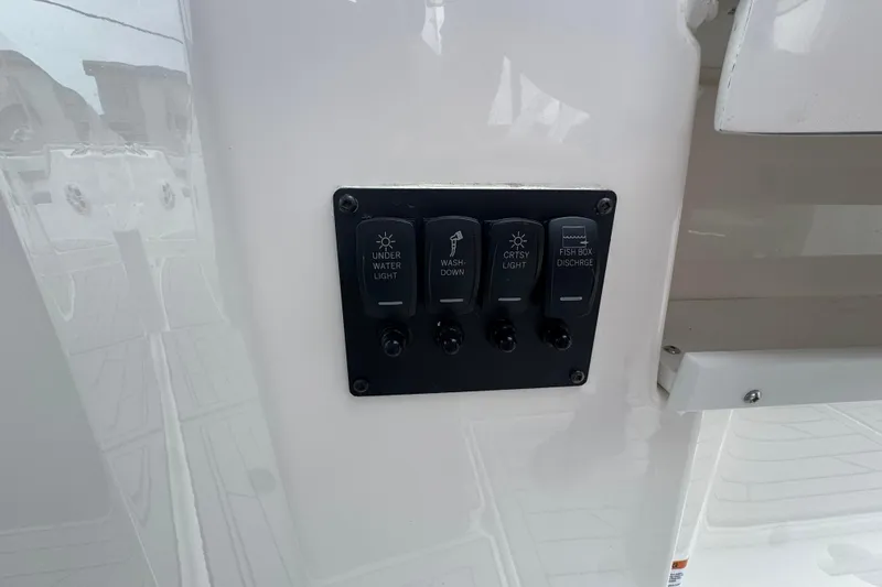 Slide: The Image of Control panel on Solara S-310 CW boat, featuring underwater light and washdown switches. - 23