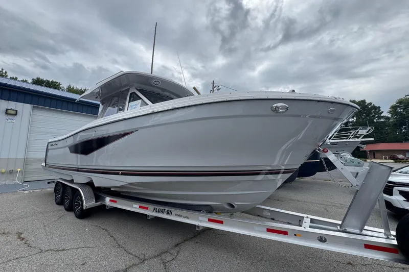 Slide: The Image of 2026 Solara S-310 CW boat on trailer, parked outdoors under cloudy sky. - 3