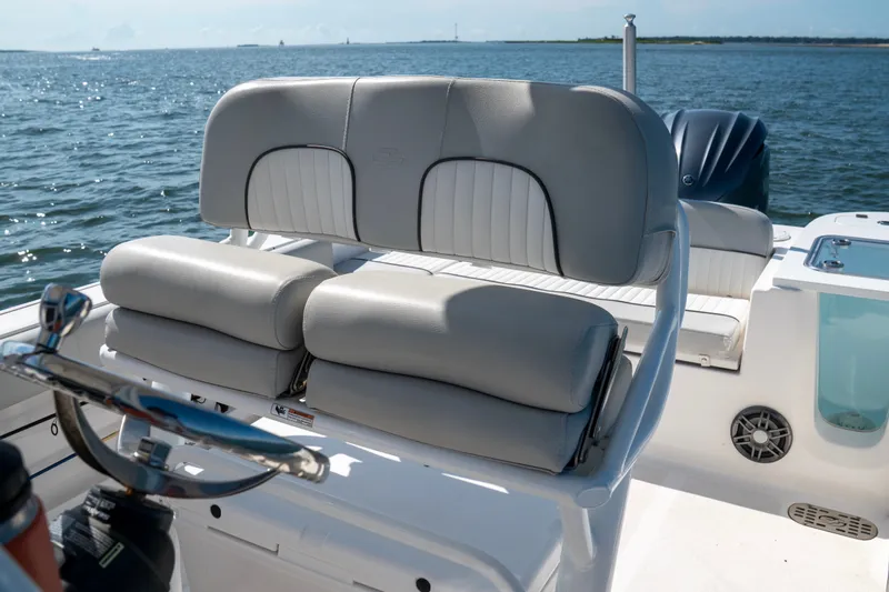 Slide: The Image of 2022 Sea Fox 248 Commander boat interior with cushioned seating and steering wheel. - 6