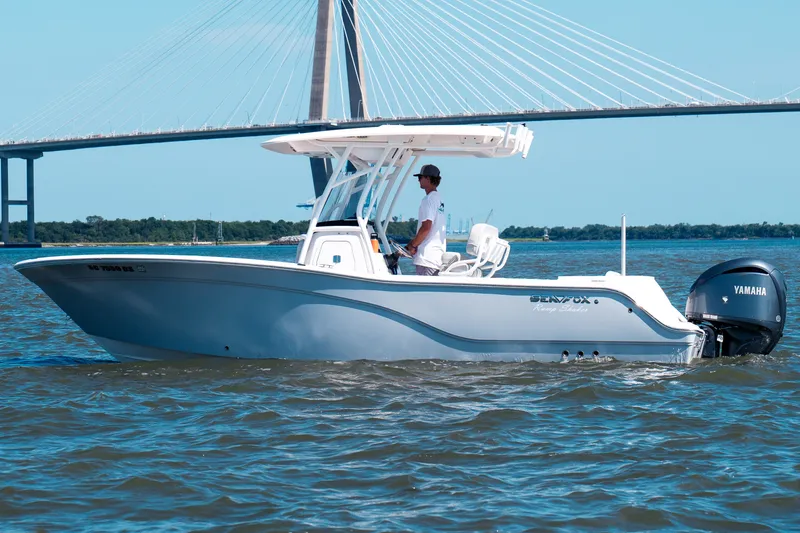 The Image of 2022 Sea Fox 248 Commander boat cruising under a bridge on a sunny day. - 1