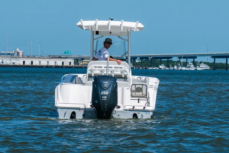 Slide: The Image of 2022 Sea Fox 248 Commander boat cruising on water with bridge in background. - 14