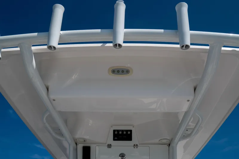 Slide: The Image of T-top view of 2022 Sea Fox 248 Commander boat against clear blue sky. - 11