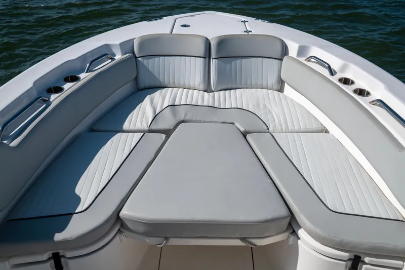 Slide: The Image of 2022 Sea Fox 248 Commander boat with cushioned seating and cup holders on deck. - 8