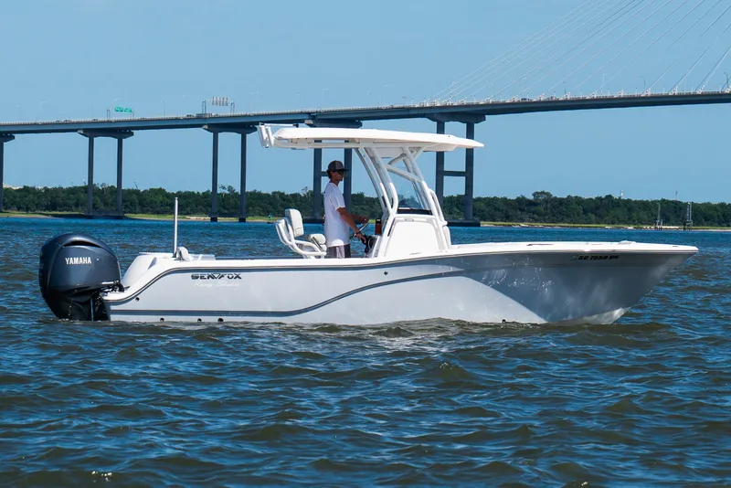 Slide: The Image of 2022 Sea Fox 248 Commander boat cruising on water near a bridge. - 18