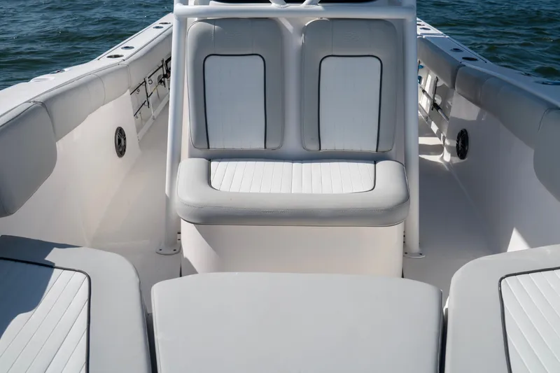 Slide: The Image of 2022 Sea Fox 248 Commander boat interior with cushioned seating and ocean backdrop. - 10