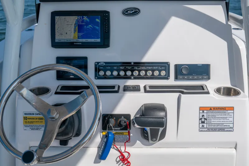 Slide: The Image of Dashboard of 2022 Sea Fox 248 Commander boat with steering wheel and navigation controls. - 4