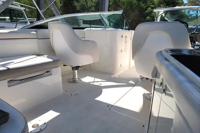 Slide: The Image of Interior view of a 2012 Sea Ray 260 Sundeck boat with white seating and sleek design. - 42