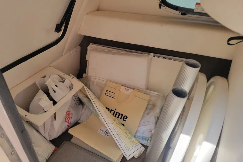 Slide: The Image of Interior storage of 2012 Sea Ray 260 Sundeck with various items and packages. - 35