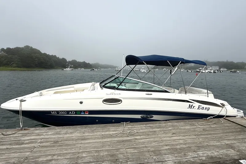 Slide: The Image of 2012 Sea Ray 260 Sundeck boat docked on a misty lake. - 24