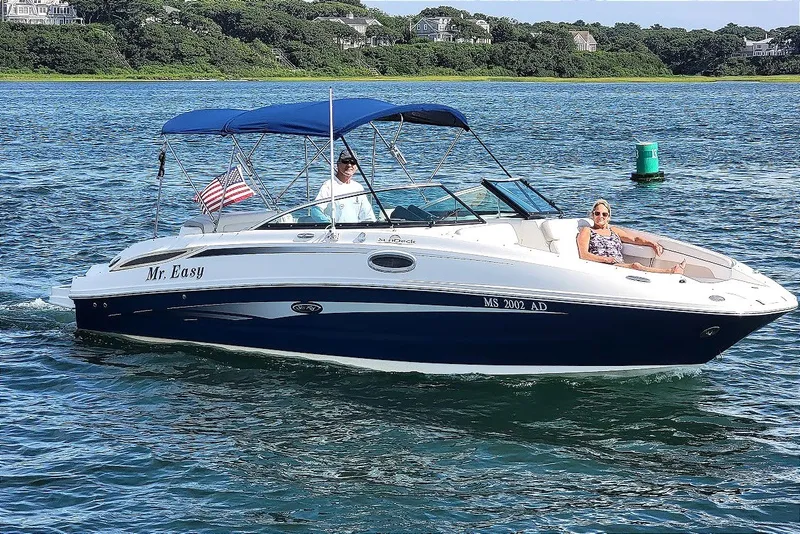 Slide: The Image of 2012 Sea Ray 260 Sundeck boat cruising on a sunny day with passengers relaxing. - 7