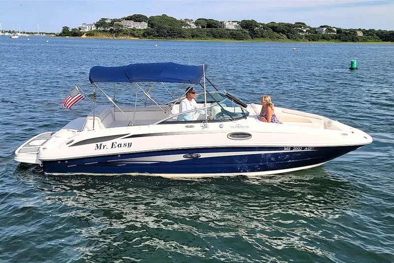 Slide: The Image of 2012 Sea Ray 260 Sundeck boat cruising on a sunny day with passengers. - 36