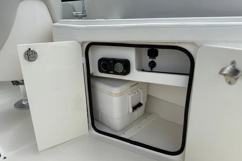 Slide: The Image of Open storage compartment on 2012 Sea Ray 260 Sundeck boat with cooler and stereo system. - 28