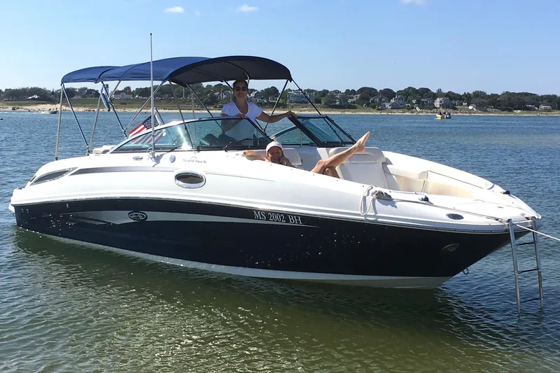Slide: The Image of 2012 Sea Ray 260 Sundeck boat on water with people relaxing onboard. - 0