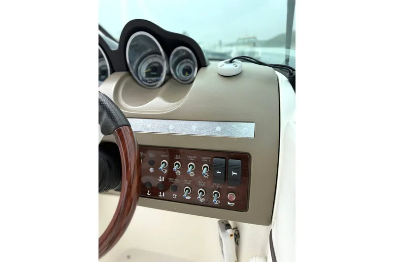 Slide: The Image of Dashboard of a 2012 Sea Ray 260 Sundeck boat with gauges and controls. - 31