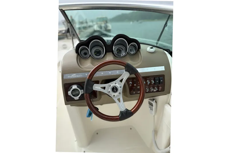 Slide: The Image of Steering console of a 2012 Sea Ray 260 Sundeck boat with gauges and controls. - 15