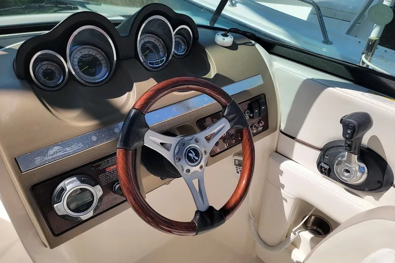 Slide: The Image of Steering wheel and dashboard of 2012 Sea Ray 260 Sundeck boat. - 2