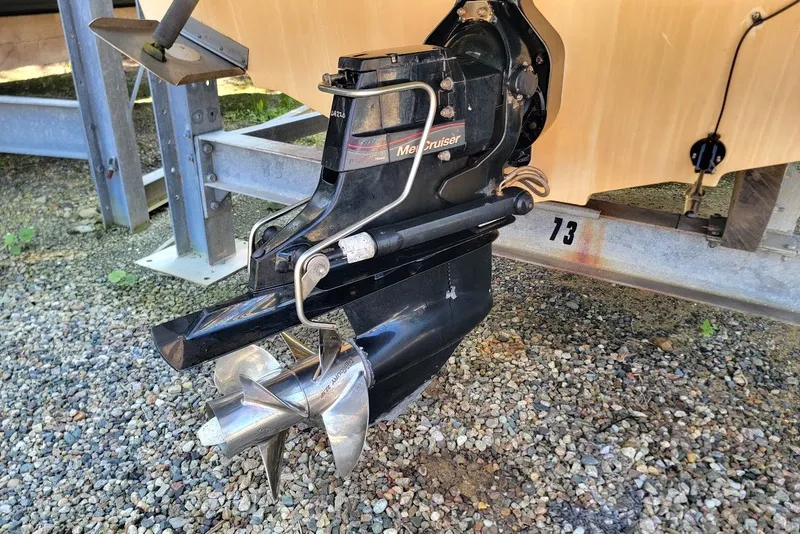Slide: The Image of 2012 Sea Ray 260 Sundeck boat with MerCruiser outdrive on gravel surface. - 23