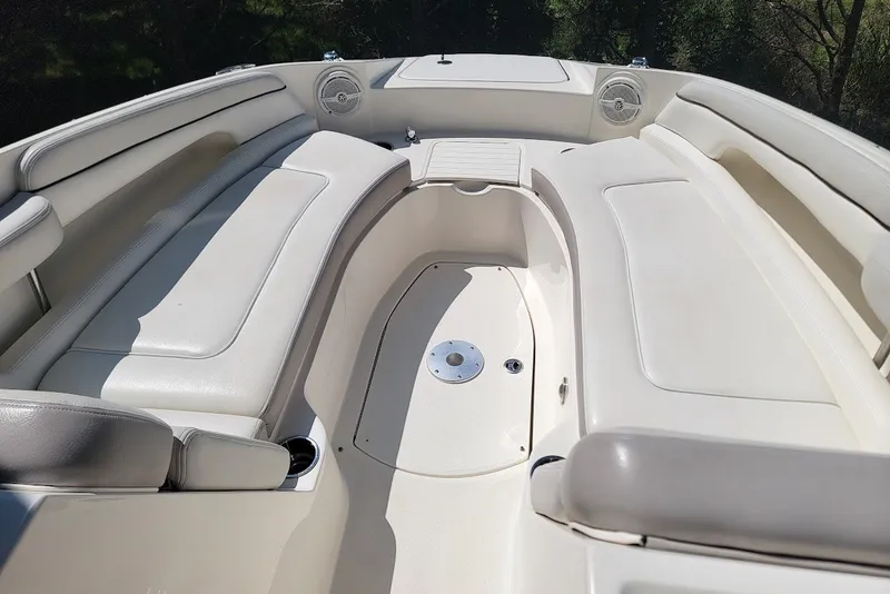 Slide: The Image of 2012 Sea Ray 260 Sundeck interior with white seating and cup holders. - 1