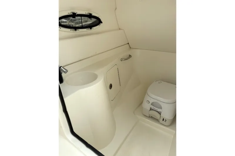 Slide: The Image of Interior of 2012 Sea Ray 260 Sundeck boat featuring compact marine toilet. - 19