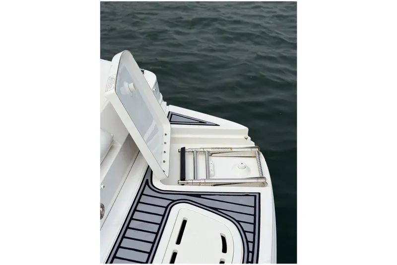 Slide: The Image of 2012 Sea Ray 260 Sundeck swim platform with ladder, open hatch, and water view. - 41