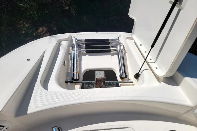 Slide: The Image of 2012 Sea Ray 260 Sundeck boat ladder compartment with open hatch. - 6