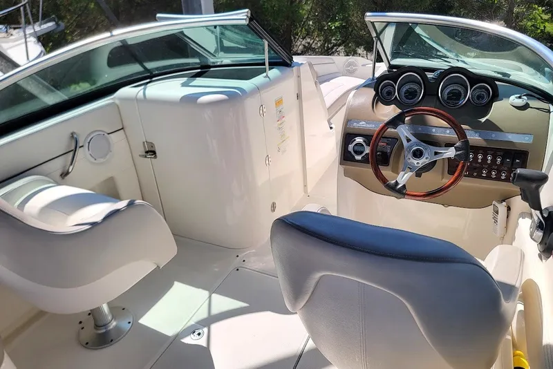 Slide: The Image of Interior of a 2012 Sea Ray 260 Sundeck boat with steering wheel and seating. - 9