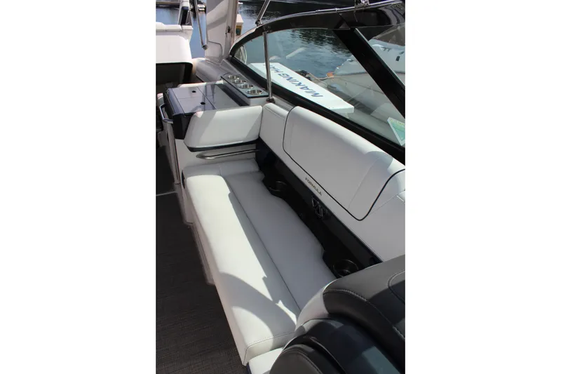 Slide: The Image of 2017 Formula 330 Crossover Bowrider interior with white seating and sleek design. - 12