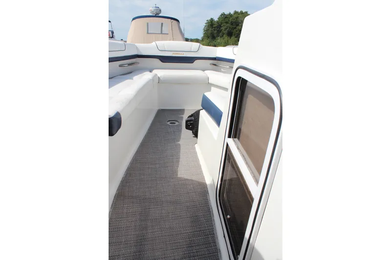 Slide: The Image of 2017 Formula 330 Crossover Bowrider interior with cushioned seating and carpeted flooring. - 17
