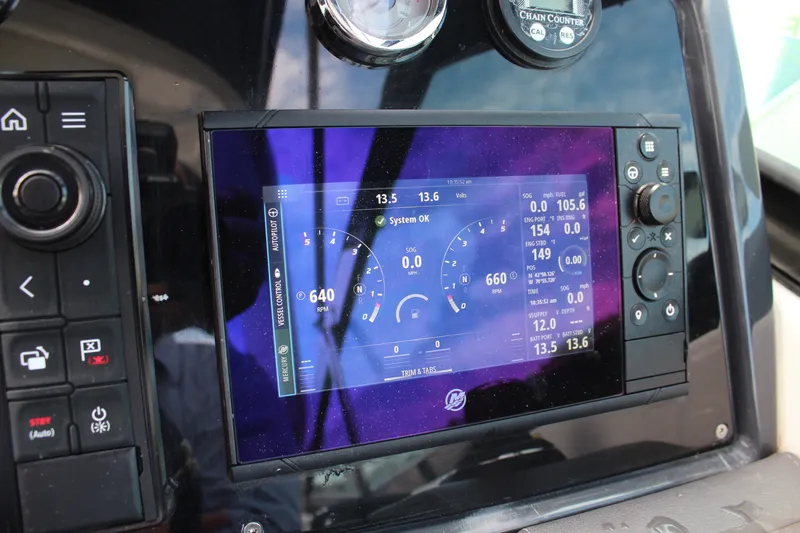Slide: The Image of Dashboard of a 2017 Formula 330 Crossover Bowrider with digital display and controls. - 23