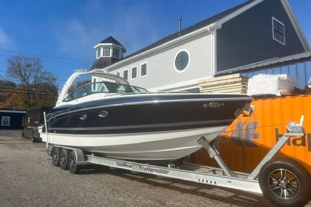 Slide: The Image of 2017 Formula 330 Crossover Bowrider on trailer, parked near a building. - 47