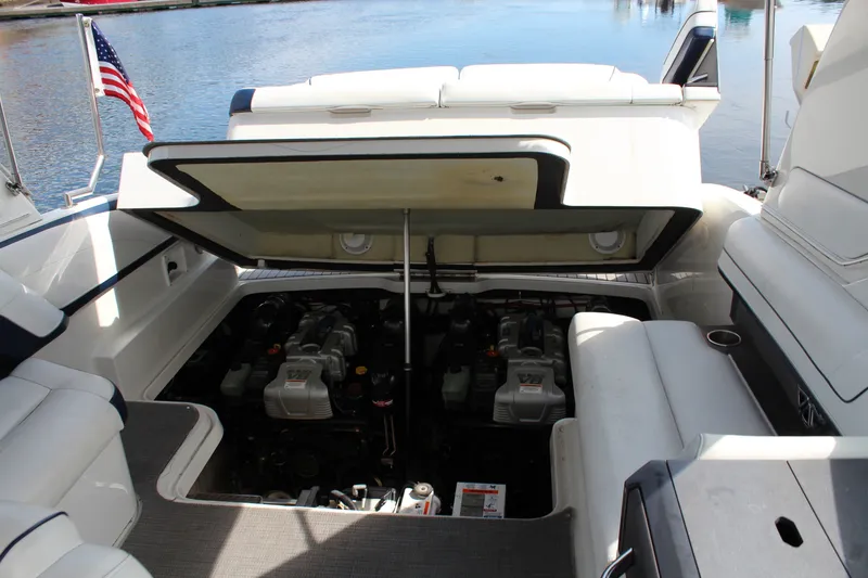 Slide: The Image of 2017 Formula 330 Crossover Bowrider engine compartment open, docked by water. - 28