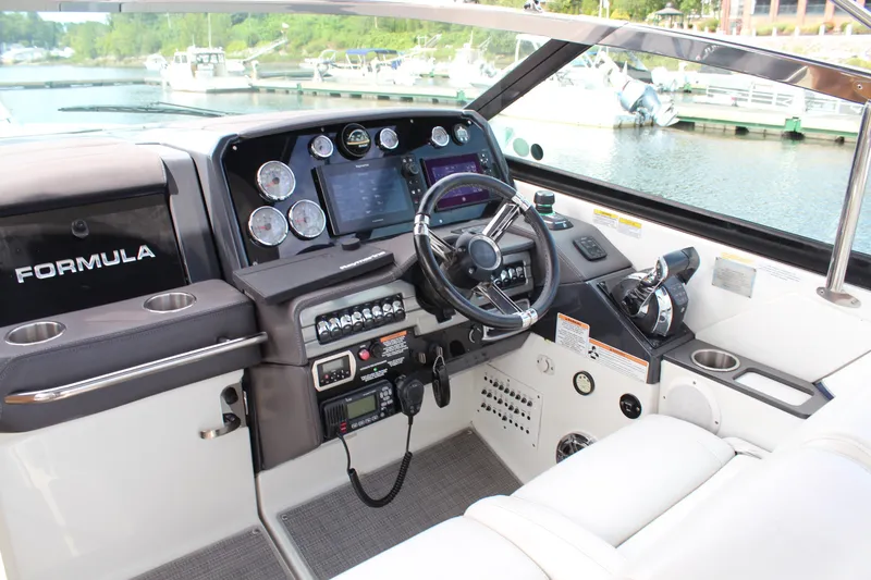 Slide: The Image of 2017 Formula 330 Crossover Bowrider helm with modern controls and navigation system. - 20