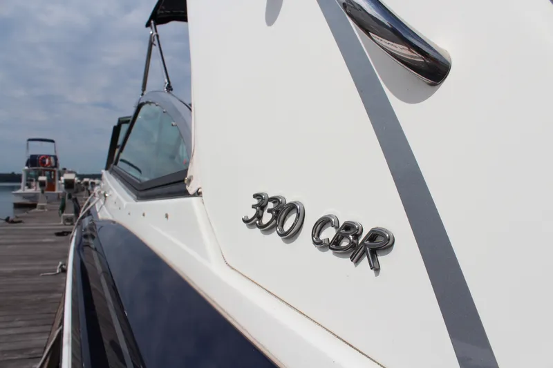 Slide: The Image of 2017 Formula 330 Crossover Bowrider docked, showcasing sleek design and branding. - 45