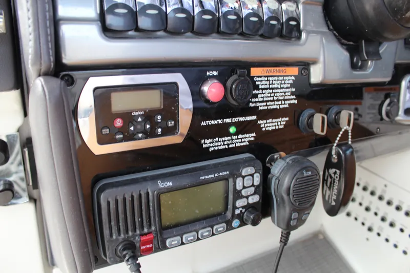 Slide: The Image of Control panel of a 2017 Formula 330 Crossover Bowrider with radio and warning labels. - 22