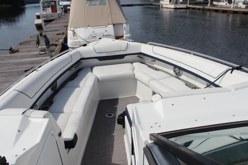 Slide: The Image of 2017 Formula 330 Crossover Bowrider with spacious seating, docked at a marina. - 13