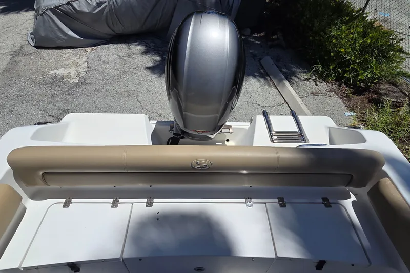 Slide: The Image of 2016 Sportsman Heritage 211 Center Console boat with outboard motor and rear seating. - 6