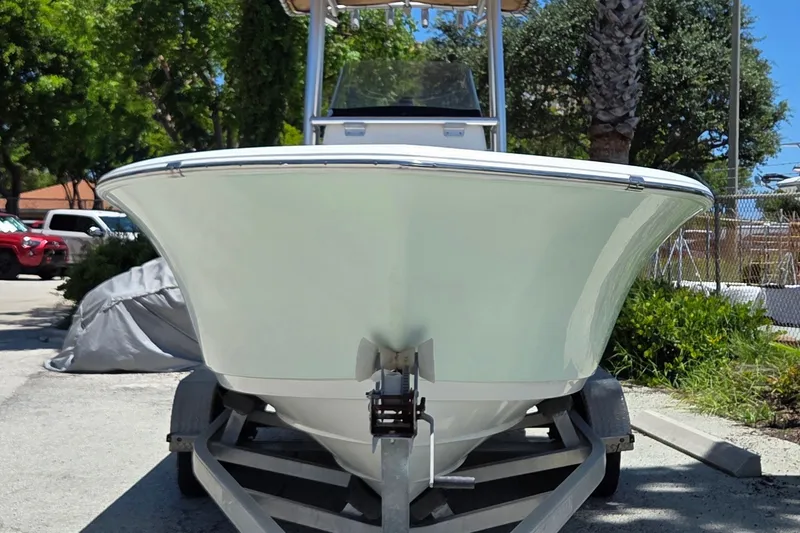 Slide: The Image of 2016 Sportsman Heritage 211 Center Console boat on trailer, parked outdoors. - 2
