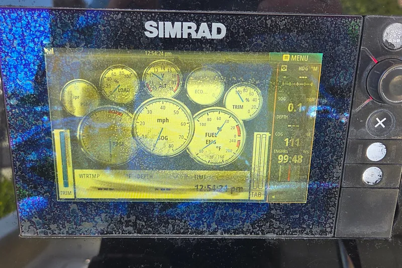 Slide: The Image of Simrad marine display on 2016 Sportsman Heritage 211 Center Console showing navigation data. - 12